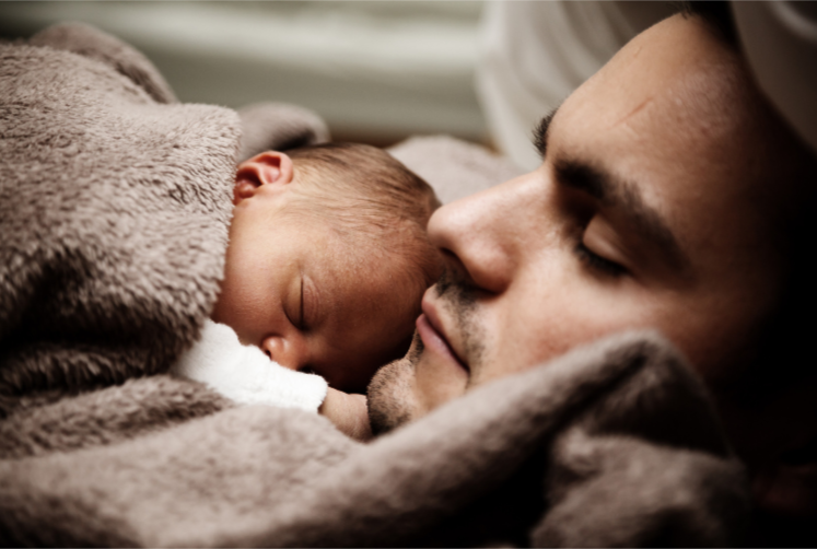 Newborn with parent after birth